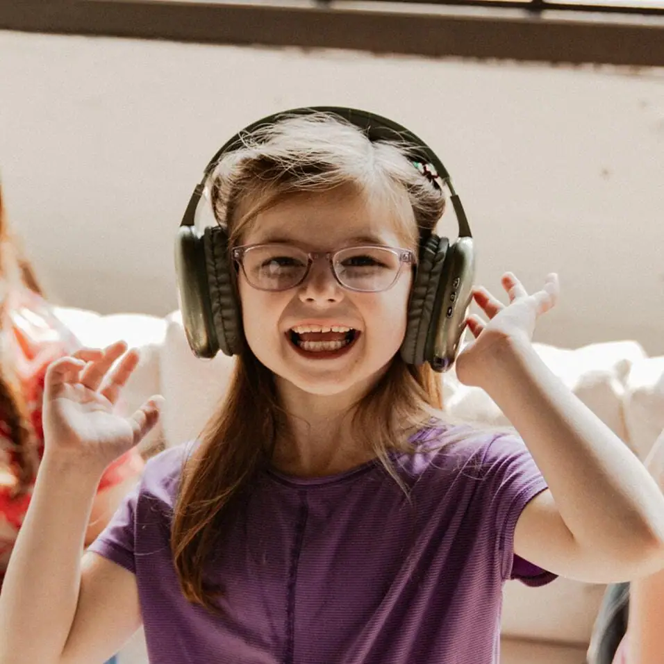 Student smiling wearing a pair of headphones