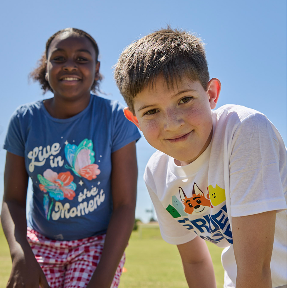 Elementary students smiling at the camera