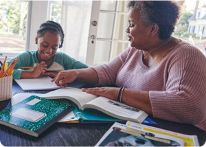 Mother and her child doing homework together at home